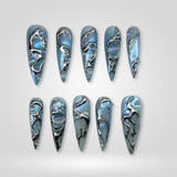 Blue Melt 3D chrome press-on nails with silvery finish on stiletto