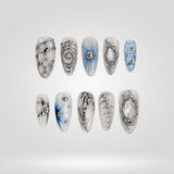 Frozen Orbit 3D press-on nails with icy white, pale blue, and sculpted silver circles