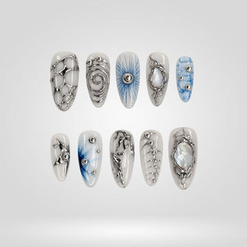 Frozen Orbit 3D press-on nails with icy white, pale blue, and sculpted silver circles