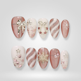 Pink Noel press-on nails with festive holiday design
