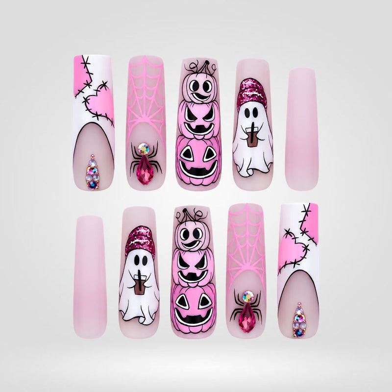 Pink Pumpkin Parade press-on nails with ghost and pumpkin designs on coffin shape