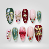 Holly Glow press-on nails — gold snowflake detail
