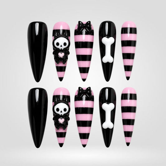 Bone Candy Skull press-on nails — pink and black on almond nails