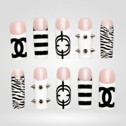 Mono Luxe hand-painted spooky press-on nails — skulls and spiderwebs on icy blue and black square nails