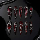 Devilish Cross press-on nails — red and black with 3D crosses and chain details, stiletto shape