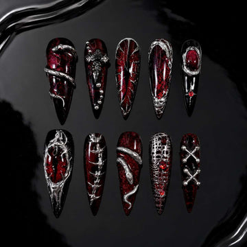 Devilish Cross press-on nails — red and black with 3D crosses and chain details, stiletto shape