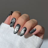 Midnight Shine cat eye press-on nails in almond shape with web and ghost design
