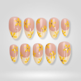 Sunny Bloom press-on nails with yellow floral French tip design