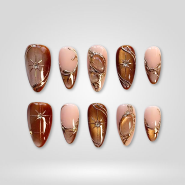 Bronze Star press-on nails — gold star accents with cat-eye on almond