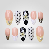 Dot Bloom press-on nails with hand-painted polka dots and 3D flowers on almond