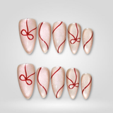 Ruby Swirl press-on nails with red line art on nude glitter