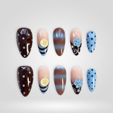 Blue Cocoa handmade press-on nails with polka dots on almond shape