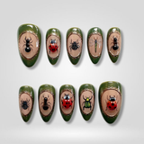 Bug Garden press-on nails — 3D ladybugs and beetles in green on almond