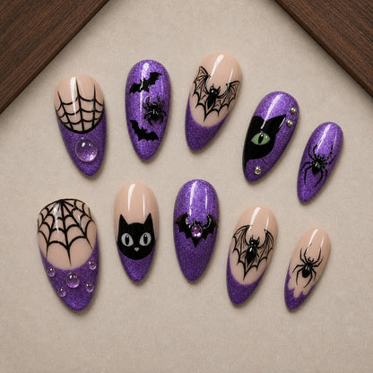 Amethyst Web Halloween press-on nail set displayed in a walnut tray — almond shape
