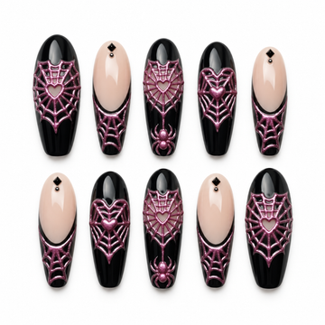 Ten coordinated glossy black and blush nude press-on nails with raised-looking metallic pink heart spiderwebs, spider accents, and dark square details on a light background.