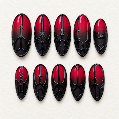 Ten glossy crimson-to-black ombré press-on nails with raised-looking gothic gate, arch, and floral-inspired black linework on a light neutral background.