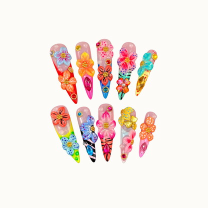 Ten pointed floral nails arranged in two rows on an off-white background, with raised multicolor petals, dotted details, stripes, and jewel accents.