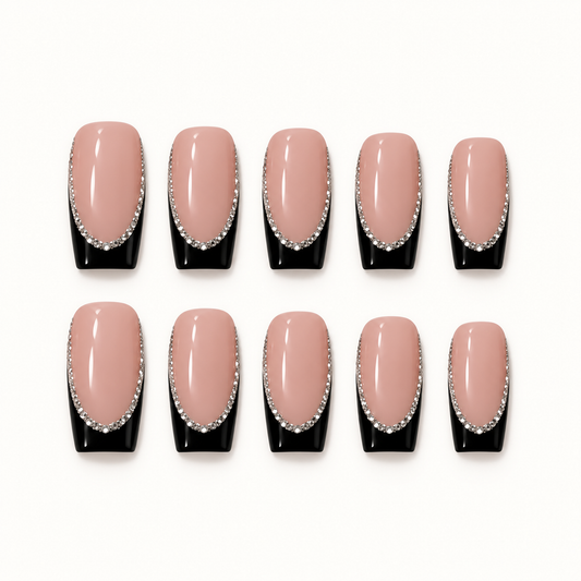 Ten glossy blush pink nails with black tips and curved silver-toned sparkling borders arranged in two rows on a light background.
