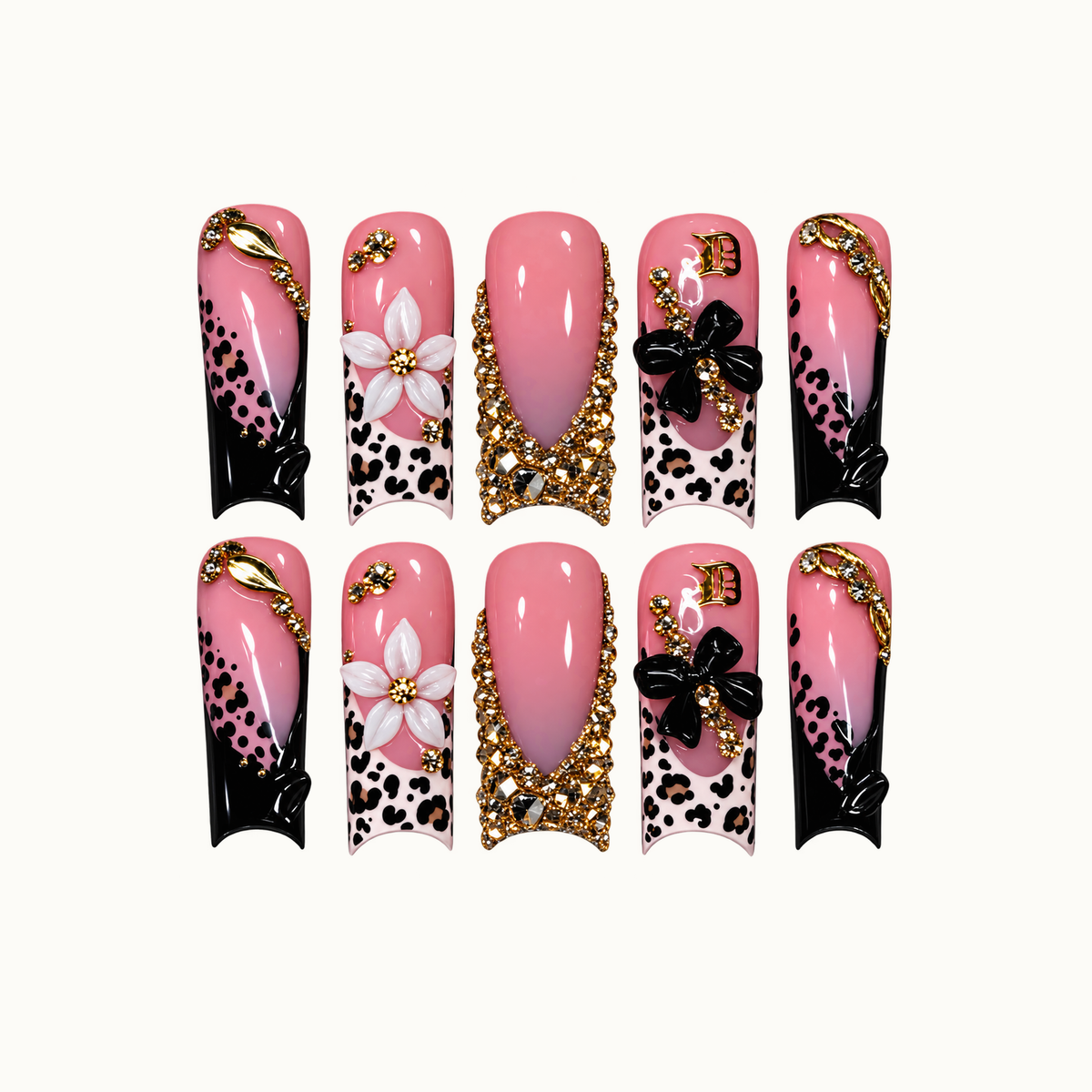 Ten pink nails arranged in two rows on a light background, featuring leopard spots, black tips, raised flowers, and gold-tone embellishments.
