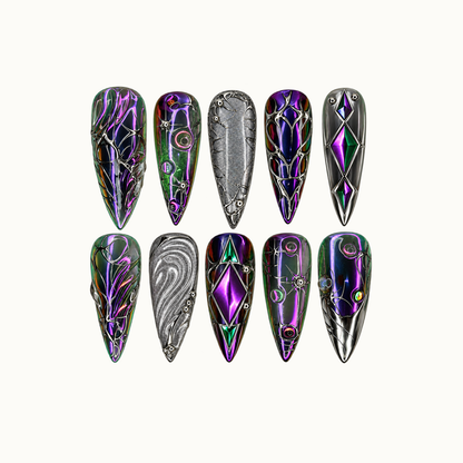 Ten pointed nails arranged in two rows on a light neutral background, featuring purple and green reflections, silver scrollwork, diamond motifs, and silver-gray accents.