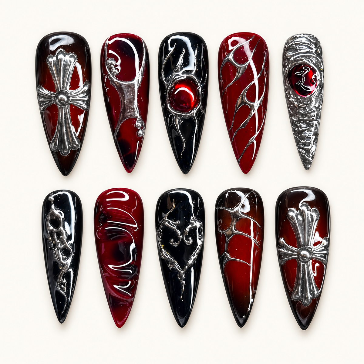 Ten glossy deep-red and black gothic press-on nails arranged in a clear case, featuring raised silver cross, chain-like, and web-inspired details.