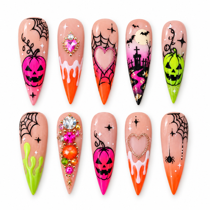 Ten coordinated Halloween press-on nails with pink and lime pumpkins, black spiderwebs, orange drips, bats, graveyard art, hearts, and gem accents.