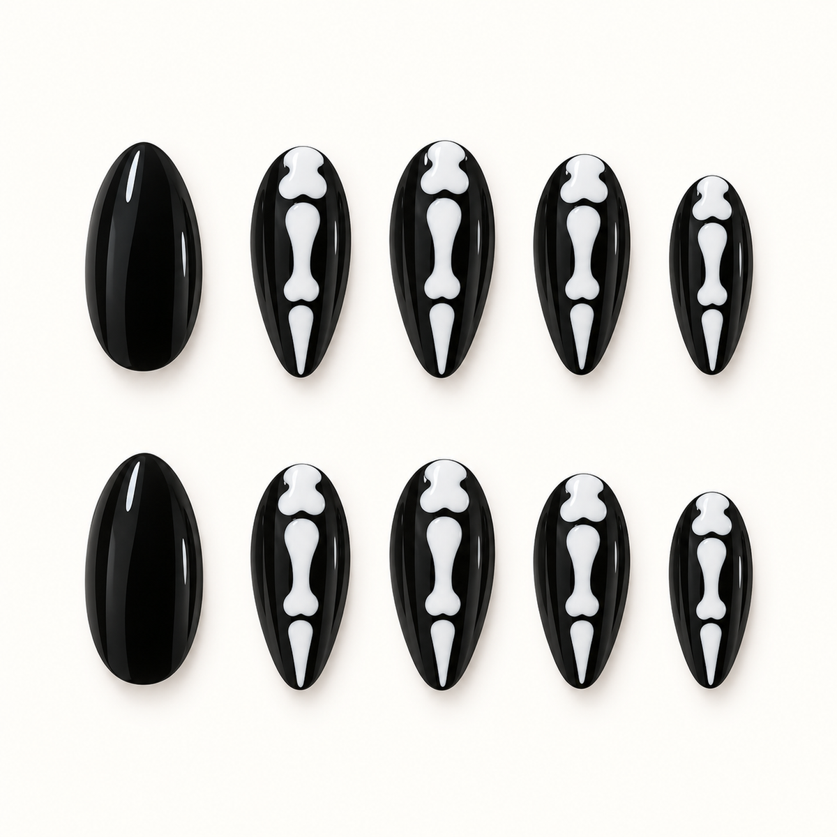Black press-on nails with white skeletal bone motifs displayed against a soft greige background.