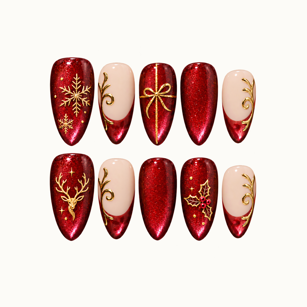 Ten ruby-red and blush press-on nails arranged in two rows, with gold-tone snowflakes, a bow, reindeer, holly, and scrollwork.