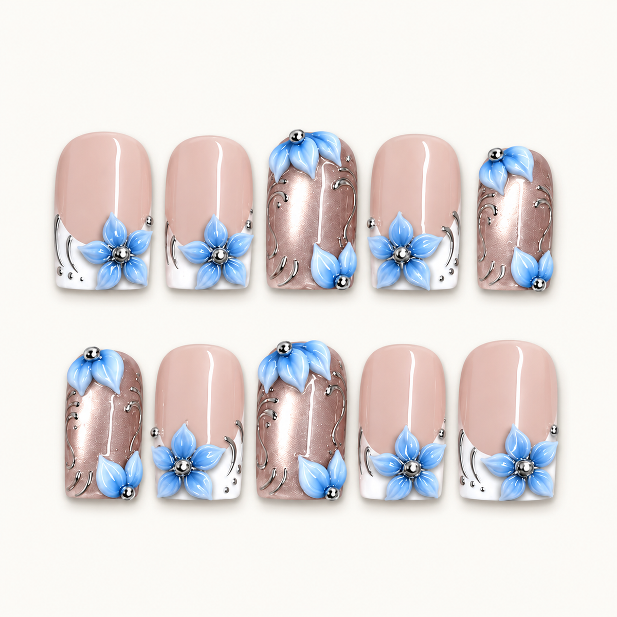 Ten Frosted Blue Petals press-on nails arranged in two rows on a light background, showing pink and white nails, rose-toned shimmer, and raised blue flowers.