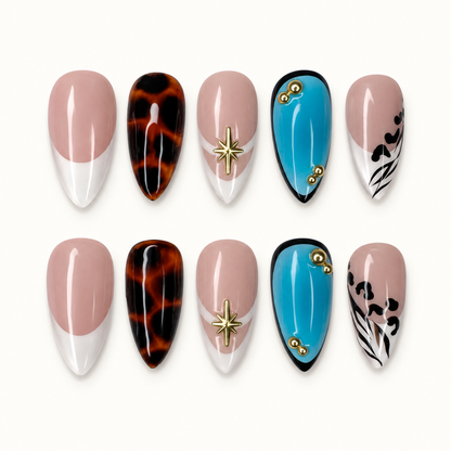 Ten coordinated nails arranged in two rows on a light background, featuring nude French tips, tortoiseshell, turquoise accents, gold-tone starbursts, and black patterned tips.
