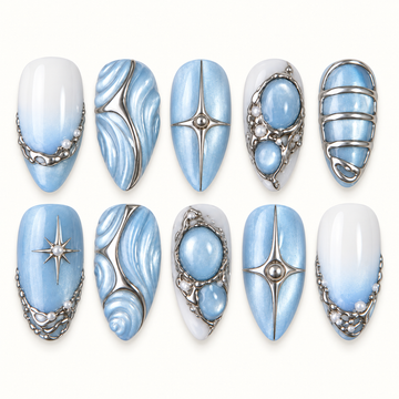 Ten Frosted Blue Tides nail designs arranged in two rows, showing icy blue swirls, white fades, silver-tone stars and bands, and raised blue ovals.