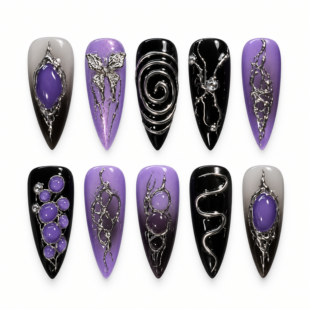 Ten glossy black and violet gothic press-on nails displayed in a clear case, with raised silver-toned spirals, scrollwork, oval accents, and abstract winged details.