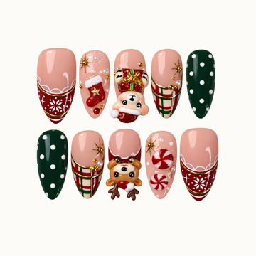 Ten Christmas press-on nails arranged in two rows on a light background, featuring red snowflake tips, green dots, plaid, peppermint swirls, and raised holiday accents.