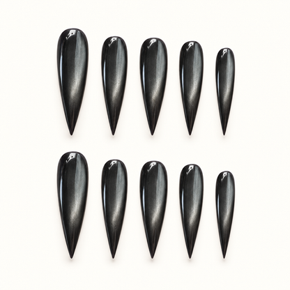 Obsidian Pearl press-on nail set with glossy black polish and smoky pewter cat-eye shimmer.