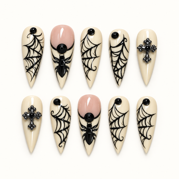 Midnight Web press-on nail set with creamy ivory tips, black spiderweb linework, spider accents, and dark cross-inspired details.