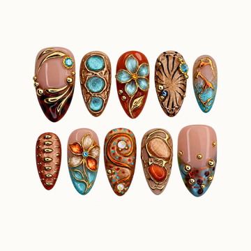 Ten coordinated nails arranged in two rows on a light background, featuring turquoise flowers, amber curves, blush sections, and gold-colored accents.
