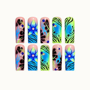 Ten glossy nails arranged in two rows on a light background, featuring blue-and-lime flowers, blue flames, black patterns, and rhinestone accents.