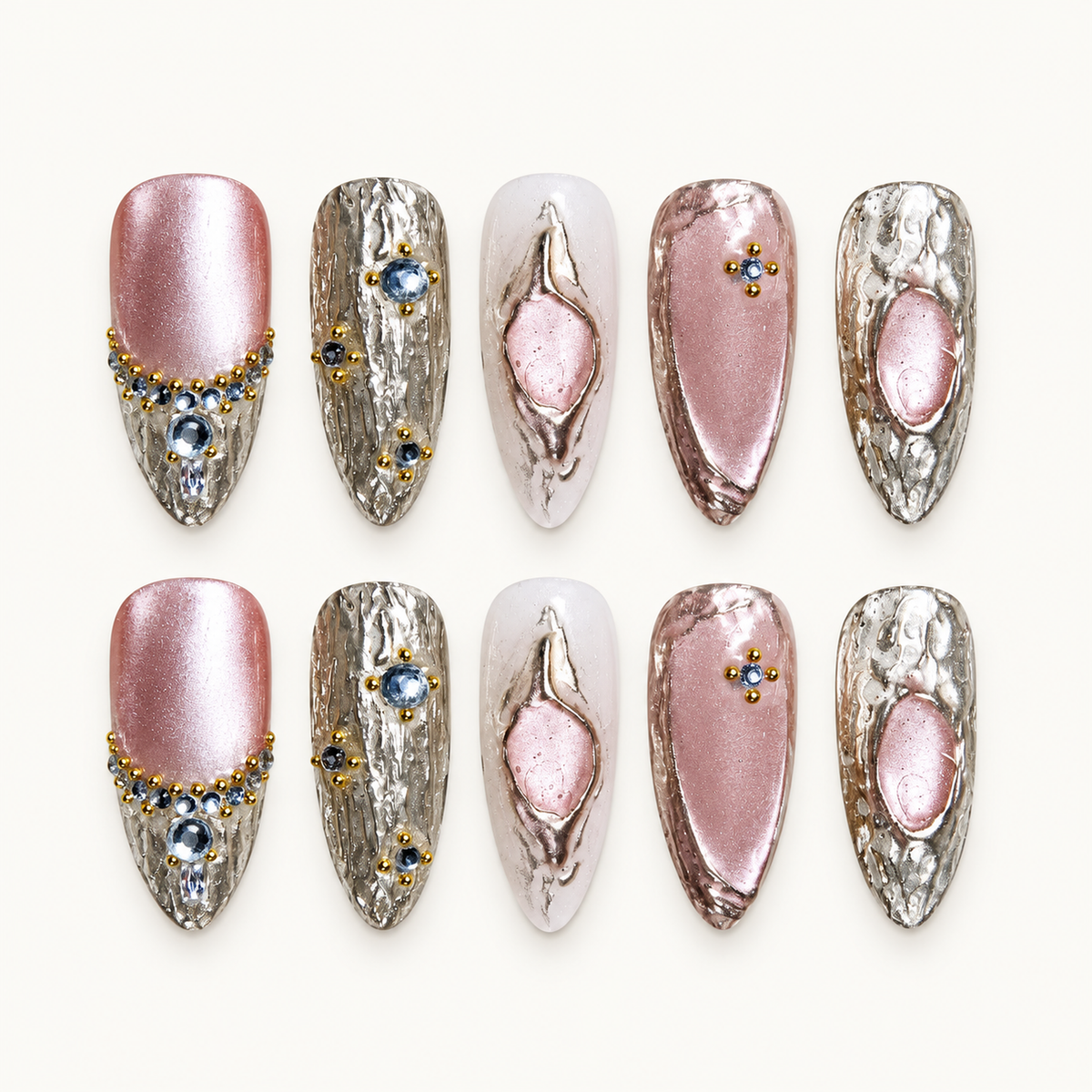 Gilded Rose Cat Eye press-on nail set with rosy pink shimmer, textured metallic accents, and crystal-like details.