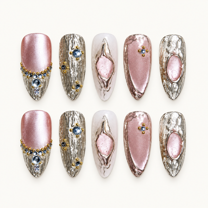 Gilded Rose Cat Eye press-on nail set with rosy pink shimmer, textured metallic accents, and crystal-like details.
