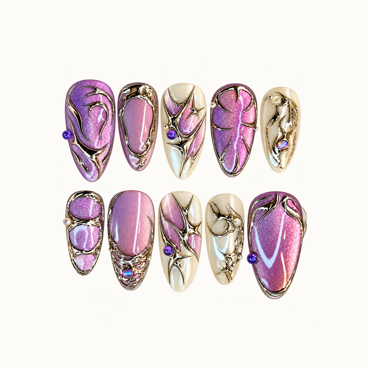 Ten pink-lilac and ivory nails arranged in two rows on a pale background, with metallic filigree and purple and pearl-like accents.