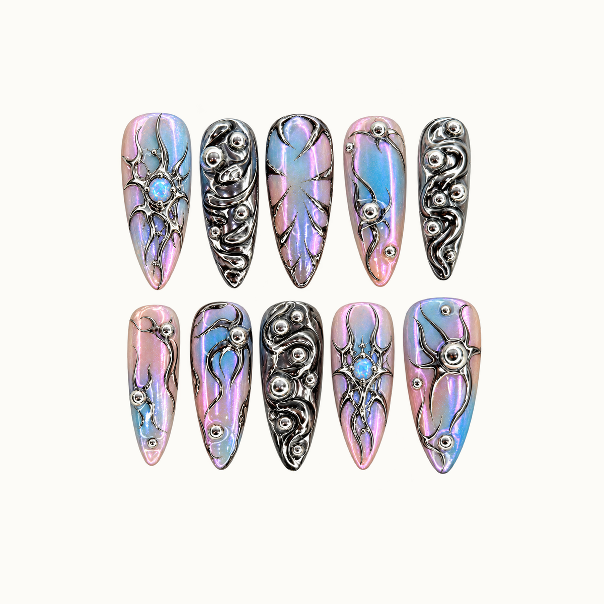 Ten pointed nails arranged in two rows on a light neutral background, featuring pink-blue iridescence, reflective silver swirls, and opal-like blue accents.