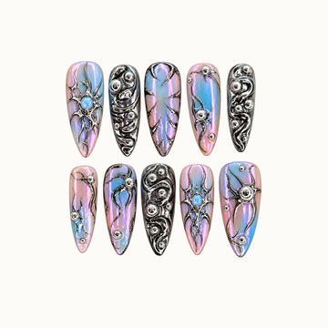 Ten pointed nails arranged in two rows on a light neutral background, featuring pink-blue iridescence, reflective silver swirls, and opal-like blue accents.