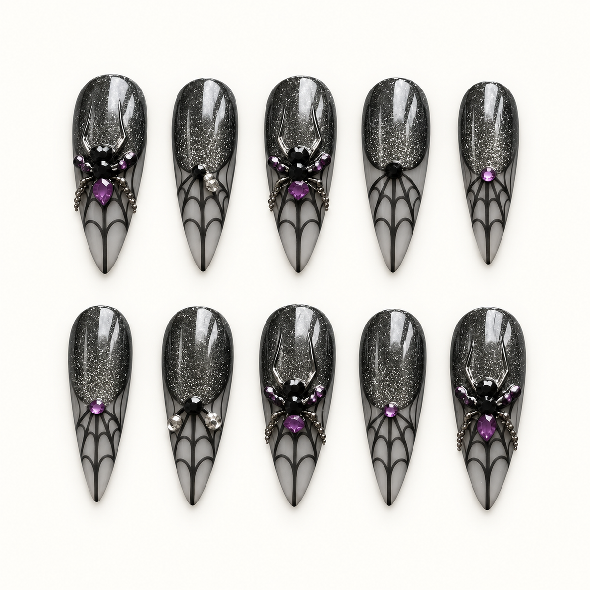 Midnight Web press-on nail set with black shimmer, smoky gray spiderweb tips, purple gems, and dimensional spider accents.