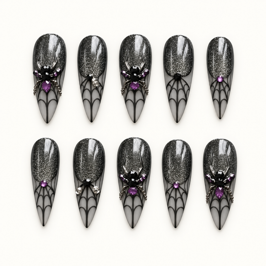 Midnight Web press-on nail set with black shimmer, smoky gray spiderweb tips, purple gems, and dimensional spider accents.