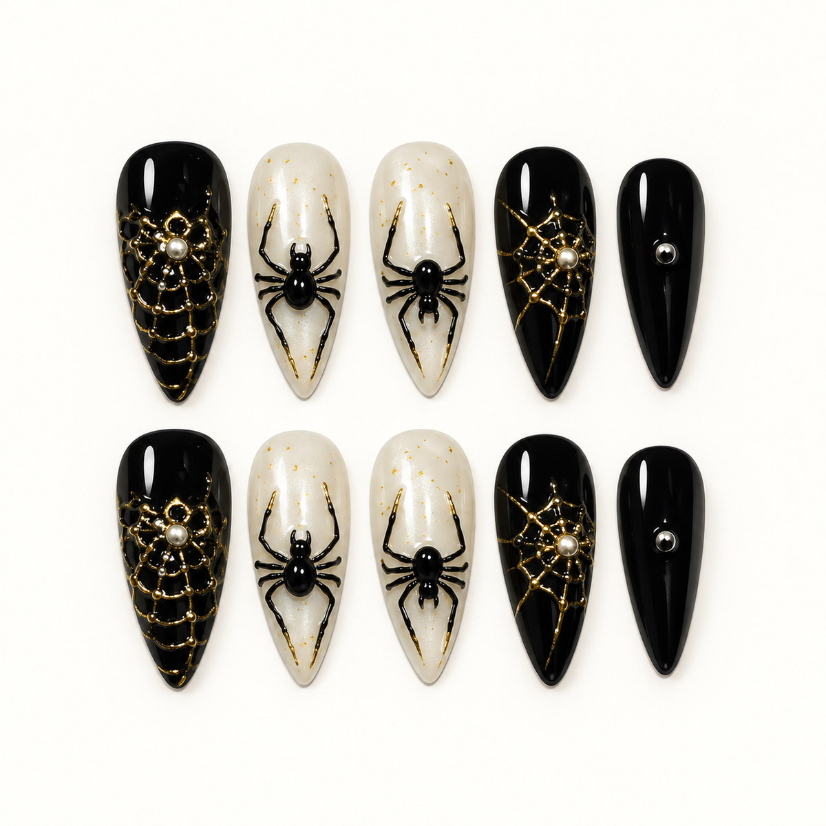 Midnight Web press-on nail set with glossy black, pearly ivory, metallic gold web details, and raised black spider accents