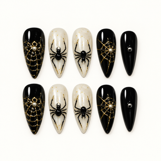 Midnight Web press-on nail set with glossy black, pearly ivory, metallic gold web details, and raised black spider accents