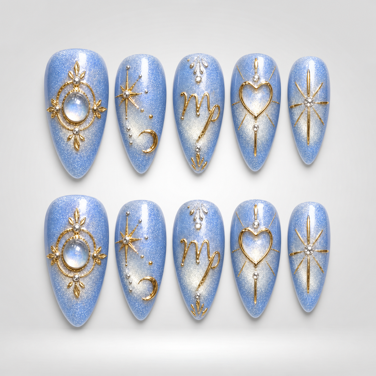 Ten coordinated light-blue shimmer press-on nails with ornate gold celestial-inspired motifs, arranged in two rows on a white background.