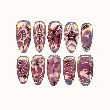 Ten mauve iridescent press-on nails arranged in two rows on a light background, with metallic stars, bows, butterflies, and curved accents.