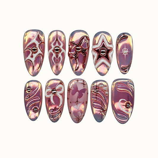 Ten mauve iridescent press-on nails arranged in two rows on a light background, with metallic stars, bows, butterflies, and curved accents.