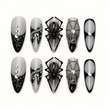 Midnight Web press-on nails in smoky gray and glossy black with dimensional spider, web, bead-chain, and crystal-inspired accents.